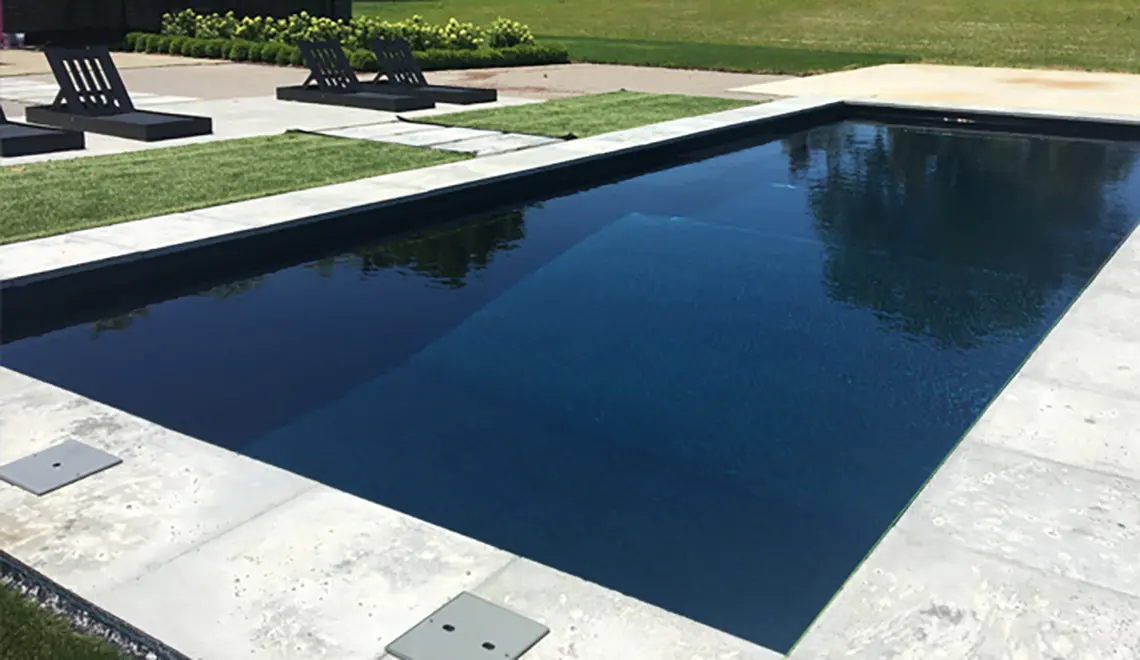 [exp_site_title] The Grand fiberglass pool large rectangular shape with an ebony blue color.